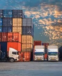 Container yard with stacked shipping containers and handling equipment